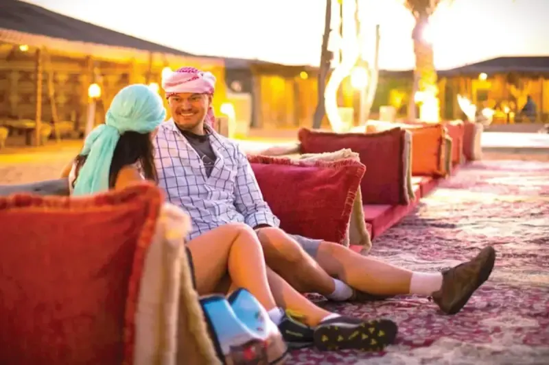 Guests relaxing in the majlis seating at a Bedouin desert camp in Dubai